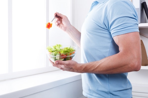 A Man. Eating a Salad.